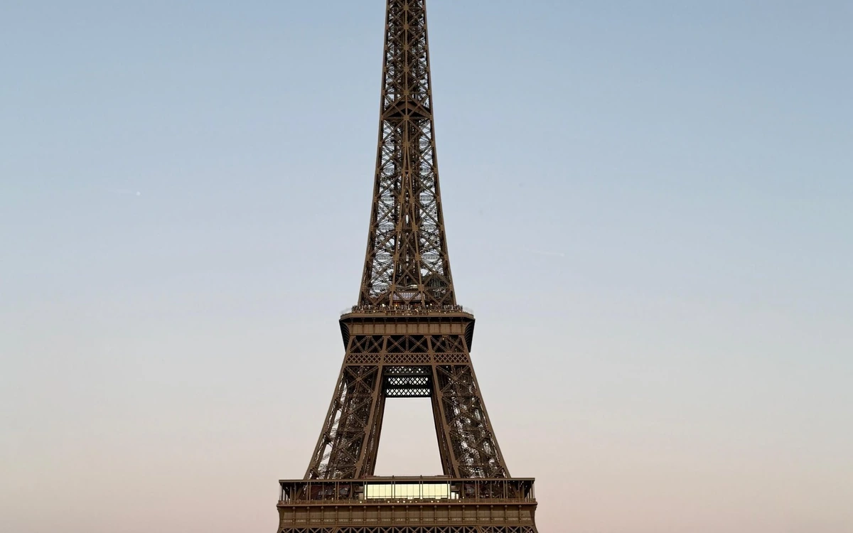 The Eiffel Tower against a clear sky, the first stop on most private routes