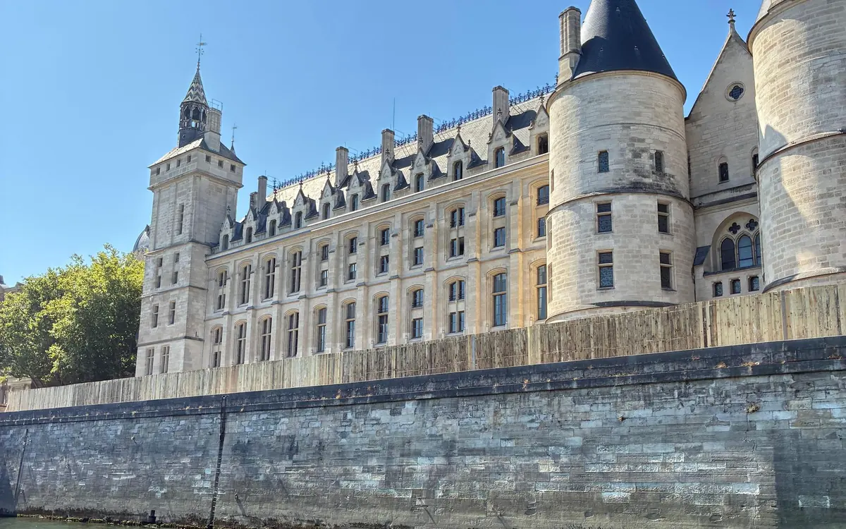 The pale towers of the Conciergerie along the river wall of the Île de la Cité