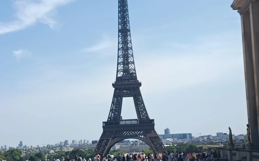 The Eiffel Tower seen from the terrace across the river, crowds below