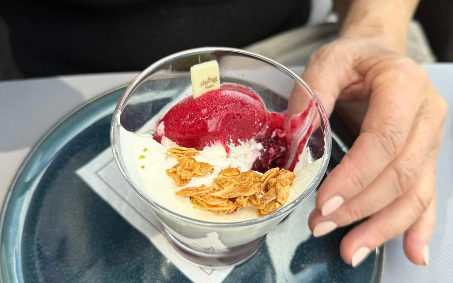 A dessert served in a glass bowl at a table on the lunch cruise