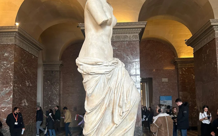 Visitors gathered around the Venus de Milo in the Louvre