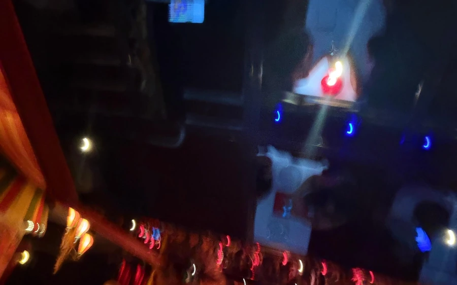 Stage lights in a dark cabaret hall during the show