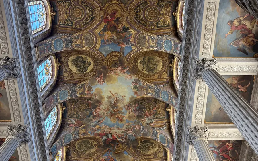 A painted ceiling with gilded cornices inside the Palace of Versailles