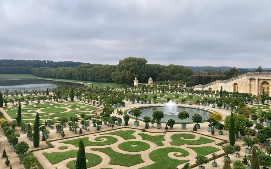 Formal parterres, a fountain and the lake in the gardens of Versailles