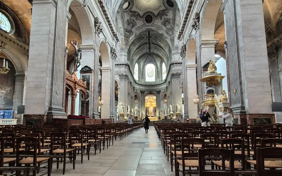 The nave and pews of a large church in the Latin Quarter