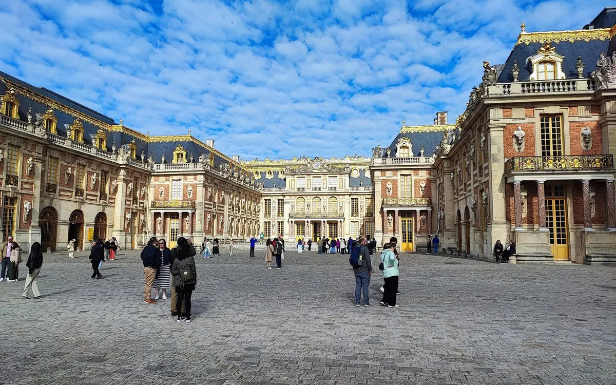 The front courtyard of the Palace of Versailles under its gilded roofs